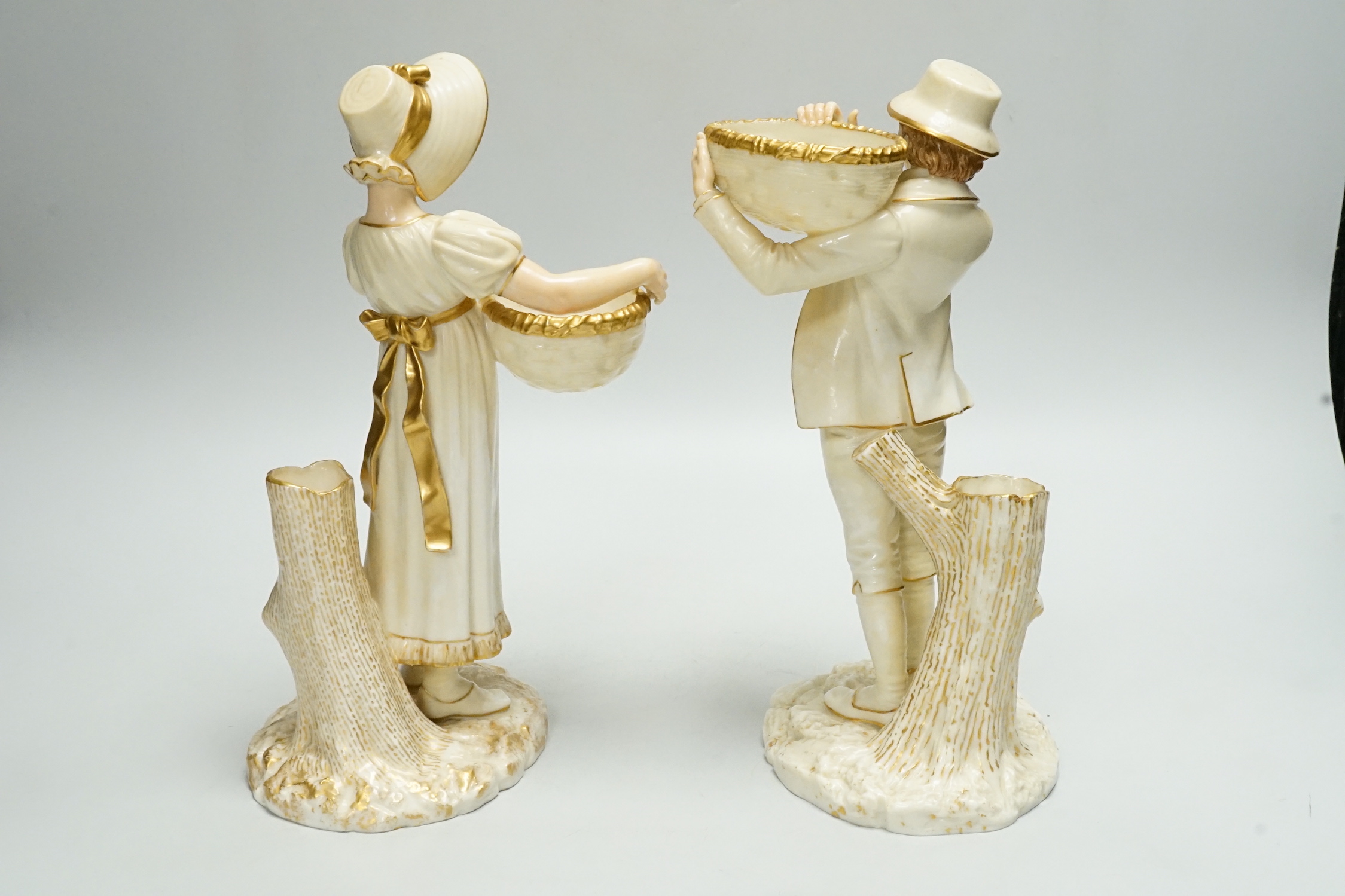 A pair of Worcester porcelain figures, modelled as a boy and girl with baskets, shape number 880, 26cm